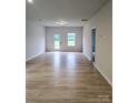 Spacious living room featuring wood-look floors, neutral paint, and abundant natural light at 2219 Catawba Trace Dr, Catawba, NC 28609
