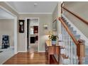 Inviting foyer with hardwood floors, stairs, and a glimpse of the kitchen at 237 Walnut Point Dr, Matthews, NC 28105
