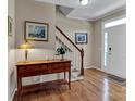Well-lit foyer with hardwood floors, a staircase, and natural light through the front door at 237 Walnut Point Dr, Matthews, NC 28105