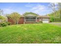 Expansive backyard featuring a screened porch and detached garage, perfect for outdoor living at 2582 Ivey Church Rd, Lincolnton, NC 28092