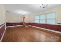 Spacious living room featuring a decorative chair rail, hardwood floors, and large windows at 2582 Ivey Church Rd, Lincolnton, NC 28092