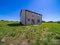 View of home's exterior backyard and trimmed grass, perfect for outdoor activities and relaxation at 3012 Isle Ln, Monroe, NC 28110