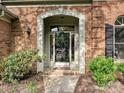 Arched entryway with verdant bushes and a wreath on the front door at 3017 Planters Walk Ct, Charlotte, NC 28210