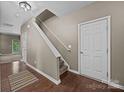 View of the home's foyer featuring wood floors, staircase and a neutral color palette at 303 Landis Oak Way, Landis, NC 28088