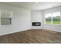 Spacious living room with wood flooring, modern fireplace, and bright windows at 3056 Ora Smith Rd, Lincolnton, NC 28092