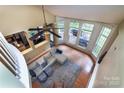 Bright, open living room featuring hardwood floors, large windows, and a comfortable sectional sofa at 3404 Pasture View Ct, Charlotte, NC 28269