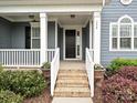 Inviting front porch with brick steps, white columns, and lush landscaping at 358 Hampton Trail Dr, Fort Mill, SC 29708