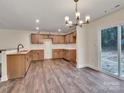 Open kitchen featuring wood cabinets, granite countertops, and stainless steel appliances at 4149 River Run Cir, Hickory, NC 28602