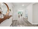 Bright entryway with hardwood floors and decorative mirror offers a welcoming feel at 476 Dudley Dr, Fort Mill, SC 29715