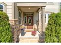 Inviting front porch with stone pillars and beautiful landscaping, creating a warm welcome at 513 Sandbar Pt, Lake Wylie, SC 29710