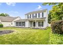 Traditional two-story home with a manicured lawn, garden beds, and mature landscaping at 6728 Mimosa St, Indian Trail, NC 28079