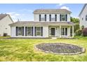 Beautiful two-story house featuring a well-maintained front yard and covered porch at 6728 Mimosa St, Indian Trail, NC 28079
