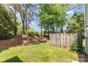 Spacious backyard with lush greenery and a wooden fence, creating a private outdoor space at 7507 Holly Grove Ct, Charlotte, NC 28227