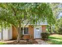 Charming townhome features brick accents, a white door, and a well-maintained front yard at 7507 Holly Grove Ct, Charlotte, NC 28227