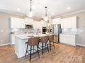 Modern kitchen with a large island, stainless steel appliances, and stylish barstool seating at 8065 Cornhill Ave, Charlotte, NC 28277