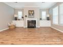 Spacious living room features a fireplace, hardwood floors, and built-in cabinets at 8065 Cornhill Ave, Charlotte, NC 28277