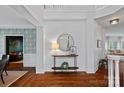 Open foyer featuring hardwood floors, a console table, and views into the dining and living areas at 8600 Glade Ct, Huntersville, NC 28078