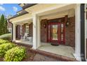 Charming front porch with classic rocking chairs and a striking red door at 110 Devonshire Ln, Salisbury, NC 28146