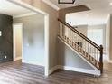Inviting entryway featuring hardwood floors and staircase with modern white and wood banister at 117 Blackbeard Ln, Mooresville, NC 28117