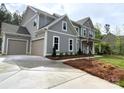 Beautiful two-story home featuring a three-car garage, landscaped yard and inviting front porch at 117 Blackbeard Ln, Mooresville, NC 28117