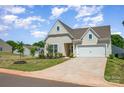 Well-maintained single-Gathering home with green lawn and a two-car garage on a sunny day at 153 Pampas Pl, Statesville, NC 28625