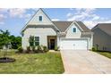 A beautiful home with a well-kept lawn and two-car garage in a Gathering-friendly neighborhood at 153 Pampas Pl, Statesville, NC 28625