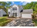 Lovely two-story home with an attached garage, driveway, and manicured lawn at 1807 Sugar Hollow Dr, Charlotte, NC 28214
