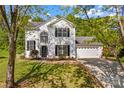 Beautiful two-story home with black shutters, and attached two-car garage at 1807 Sugar Hollow Dr, Charlotte, NC 28214