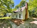 A charming two-story home featuring classic design elements and a brick chimney at 2113 Killarney Pl, Charlotte, NC 28262