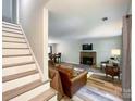 Inviting living room features a brick fireplace, hardwood floors, and ample natural light at 2113 Killarney Pl, Charlotte, NC 28262