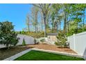 Spacious fenced backyard with a grassy area and a storage shed at 2141 Talbert Ct, Charlotte, NC 28214