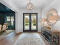 Elegant foyer featuring hardwood floors, a stylish mirror, and ample natural light, creating a welcoming entrance at 2343 Vernon Dr, Charlotte, NC 28211