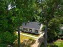 Beautifully renovated home featuring a classic white exterior, black shutters, and a well-manicured lawn at 2601 Pinewood Rd, Gastonia, NC 28054