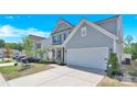 Inviting two-story home with a well-manicured lawn and attached two-car garage at 3153 Pinehills Way, Mount Holly, NC 28120