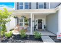 Cozy front porch featuring rocking chairs and decorative plants at 3153 Pinehills Way, Mount Holly, NC 28120