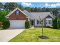 Charming single-Gathering home featuring a brick and siding facade, a well-manicured lawn, and an attached two-car garage at 4160 Isle Of Pines Dr, Denver, NC 28037