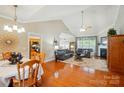 Inviting living room with hardwood floors, vaulted ceilings, a cozy fireplace, and abundant natural light at 4160 Isle Of Pines Dr, Denver, NC 28037