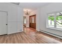 Inviting home foyer with hardwood floors, chandelier, wood front door, and window view at 455 W Gleneagles Rd, Statesville, NC 28625