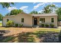Charming renovated ranch-style home featuring new siding and well-maintained landscaping at 504 N Hawthorne St, Mount Holly, NC 28120