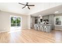 Open-concept kitchen and living area, complete with stainless appliances, quartz counters, and outdoor deck access at 504 N Hawthorne St, Mount Holly, NC 28120