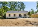 Attractive single-story home features a well-maintained lawn, gray accents, a cozy front porch and welcoming entrance at 5514 Milford Rd, Charlotte, NC 28210