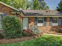 Close up of a brick home's entrance with manicured landscaping at 5601 Londonderry Rd, Charlotte, NC 28210