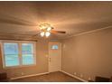 Cozy living room with carpet, ceiling fan and view of front yard at 609 E Maine Ave, Bessemer City, NC 28016