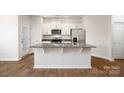 Well-lit kitchen boasts a central island with granite countertops at 6157 Helens Rest Ln, Lincolnton, NC 28092