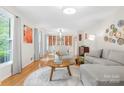 Bright living room with hardwood floors, comfortable seating, and built-in dining display at 722 12Th Nw Ave, Hickory, NC 28601