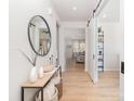 Inviting entryway with stylish decor, wood flooring, decorative mirror, and view to the living area at 8011 Green Heron Ct, Belmont, NC 28012