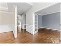 Spacious entryway featuring hardwood floors, elegant molding, and a view of a room through glass paned french doors at 9009 Tayside Ct, Huntersville, NC 28078