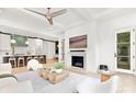 Open-concept living room with a fireplace seamlessly connecting to the kitchen and dining area at 9020 Tynecastle Commons Ct, Charlotte, NC 28226