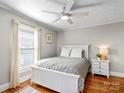 Bright bedroom with a large window, hardwood floors, and a comfortable bed at 912 W A St, Kannapolis, NC 28081