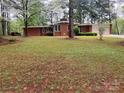 Lovely red brick home with a well-manicured lawn and blossoming trees at 1012 Hawkinstown Rd, Salisbury, NC 28144